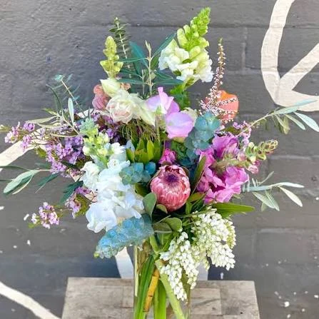Colourful mixed flower arrangement in a glass vase at Midnight Flowers